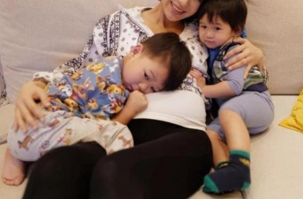 胡杏儿挺7月孕肚抱俩娃，大儿子趴在肚子上，小儿子乖巧紧靠怀中